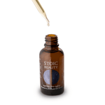 Anti-aging skincare serum being dropped from dropper.